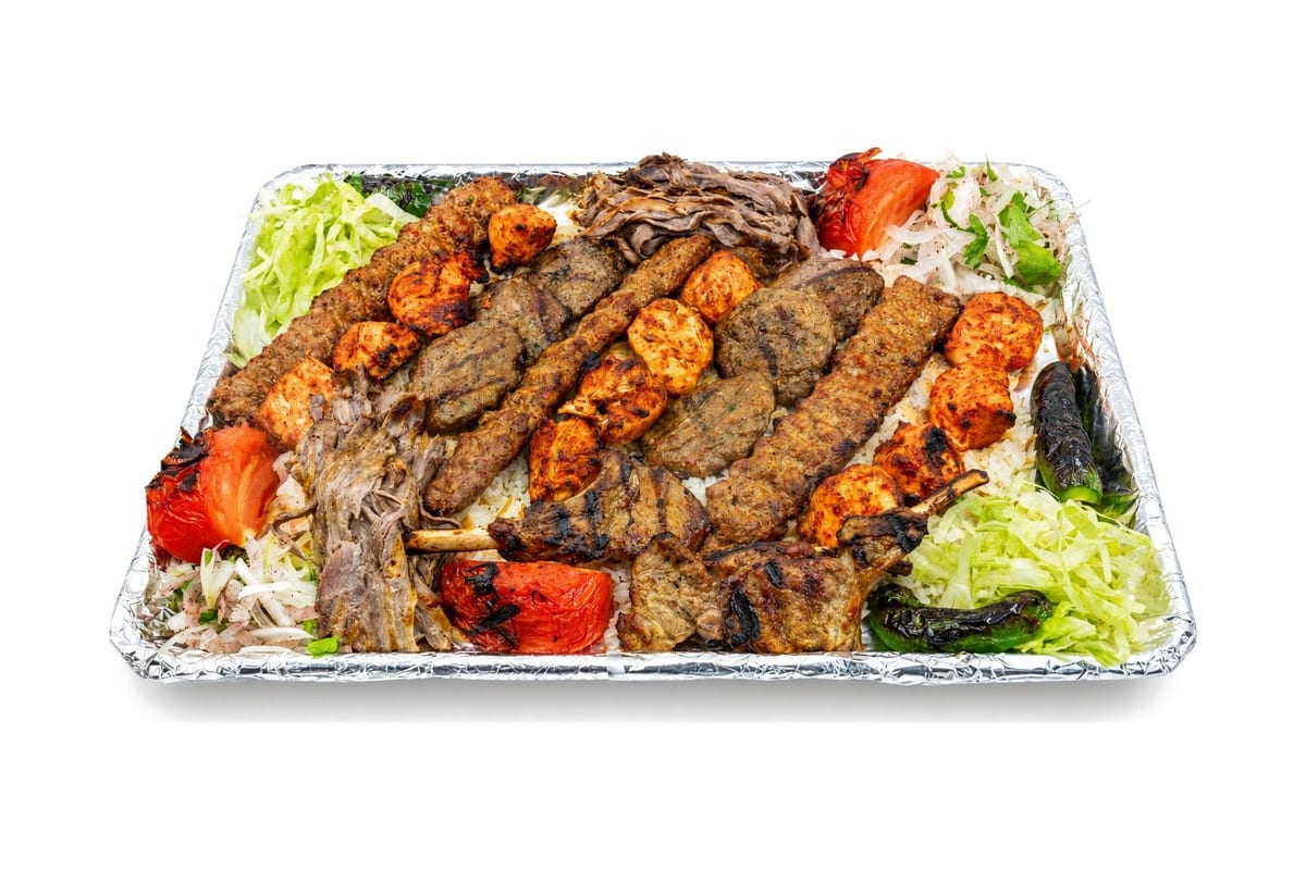 Catering tray of mixed grilled kebabs, chicken, vegetables and salad